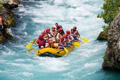 Team paddling together down rapids