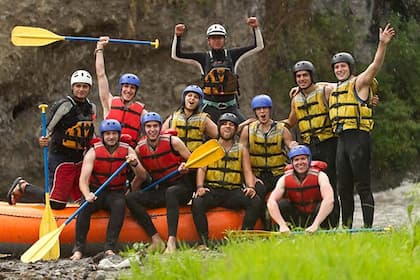 Team paddling together down rapids